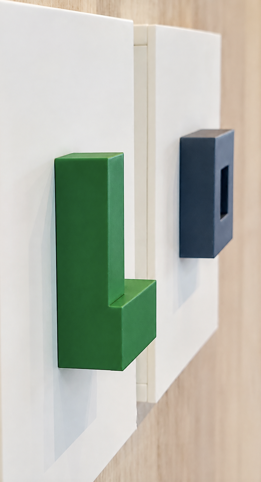 Mind Terrain (2026), side view of green and navy geometric forms mounted on white panels